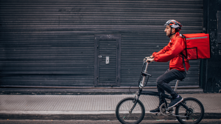 Food deliverer cycling on the right side of the picture